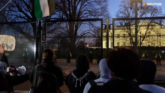Pro-Palestinian protesters try to tear down a fence near the White House