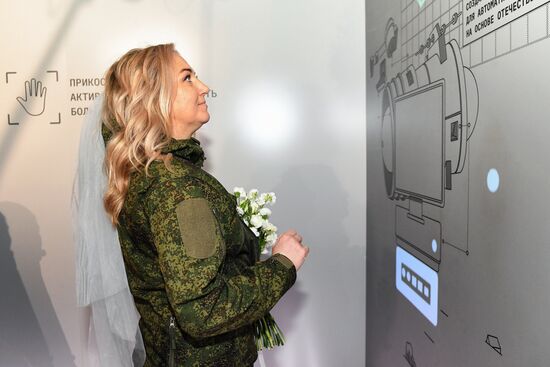 The International RUSSIA EXPO Forum and Exhibition. A wedding for special military operation personnel marking the anniversary of the SMO launch. The pavilion of the Ministry of Industry and Trade. Yulia, a volunteer involved in the special military operation. Location: Russia, Moscow. Author: Ekaterina Chesnokova/Sputnik. RUSSIA EXPO. Special military operation participants' marriage ceremony on anniversary of its launch