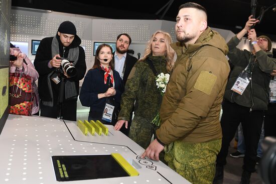 The International RUSSIA EXPO Forum and Exhibition. A wedding for special military operation personnel marking the anniversary of the SMO launch. The pavilion of the Ministry of Industry and Trade. Yulia and Yevgeny, volunteers involved in the special military operation. Location: Russia, Moscow. Author: Ekaterina Chesnokova/Sputnik. RUSSIA EXPO. Special military operation participants' marriage ceremony on anniversary of its launch