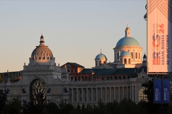 A view shows a banner with the logo of the upcoming 16th BRICS Summit, with the Palace of Farmers and the Kazan Icon of Virgin Mary Cathedral seen in the background, in Kazan, Republic of Tatarstan, Russia. Location: Russia, Republic of Tatarstan, Kazan. Author: Maksim Bogodvid. Preparations for 16th BRICS Summit in Kazan