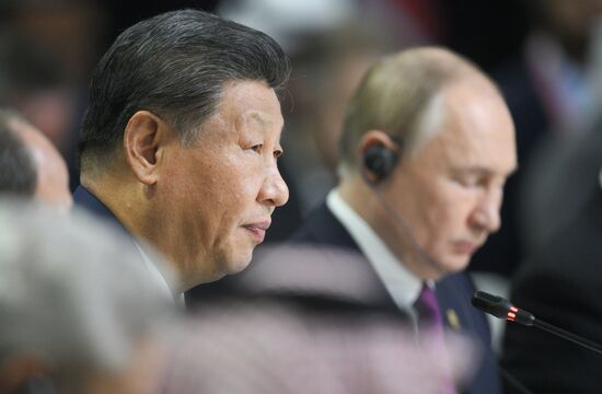 President of Russia Vladimir Putin and President of China Xi Jinping, left, during the plenary session of the Outreach/BRICS Plus meeting. Location: Russia, Republic of Tatarstan, Kazan. Author: Ramil Sitdikov. 16th BRICS summit. Outreach/BRICS Plus meeting. Plenary session