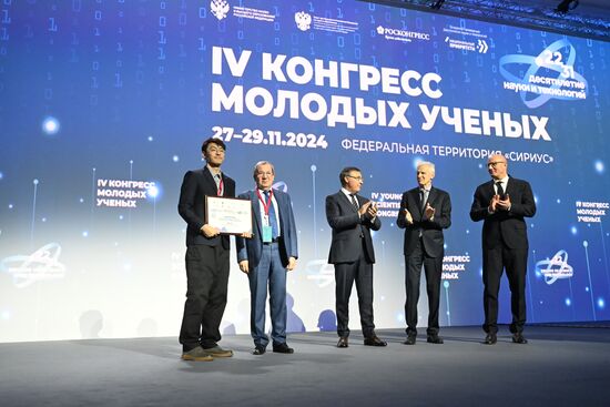 The 4th Young Scientists Congress. Plenary session. Winners of the BRICS Contest of Young Innovators announced. Award ceremony. From left: Xin Cai, innovator, China; Gennady Krasnikov, President of the Russian Academy of Sciences; Valery Falkov, Minister of Science and Higher Education of the Russian Federation; Andrei Fursenko, Aide to the President of the Russian Federation; and Dmitry Chernyshenko, Deputy Prime Minister of the Russian Federation. Location: Russia, Federal territory 'Sirius'. Author: Ilya Pitalev. 4th Young Scientists Congress. Plenary session
