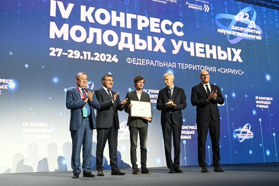 The 4th Young Scientists Congress. Plenary session. Winners of the BRICS Contest of Young Innovators announced. Award ceremony. From left: Gennady Krasnikov, President of the Russian Academy of Sciences; Valery Falkov, Minister of Science and Higher Education of the Russian Federation; Dmitry Shadrin, winner of the BRICS Young Innovator Prize (3rd place); Andrei Fursenko, Aide to the President of the Russian Federation; Dmitry Chernyshenko, Deputy Prime Minister of the Russian Federation. Location: Russia, Federal territory 'Sirius'. Author: Ilya Pitalev. 4th Young Scientists Congress. Plenary session