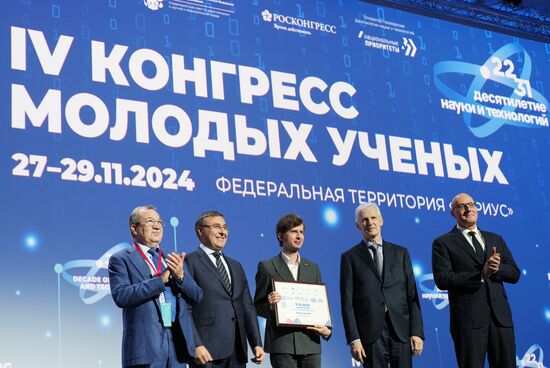The 4th Young Scientists Congress. Plenary session. Winners of the BRICS Contest of Young Innovators announced. Award ceremony. From left: Gennady Krasnikov, President of the Russian Academy of Sciences; Valery Falkov, Minister of Science and Higher Education of the Russian Federation; Dmitry Shadrin, winner of the BRICS Young Innovator Prize (3rd place); Andrei Fursenko, Aide to the President of the Russian Federation; and Dmitry Chernyshenko, Deputy Prime Minister of the Russian Federation. Location: Russia, Federal territory 'Sirius'. Author: Alexander Vilf. 4th Young Scientists Congress. Plenary session