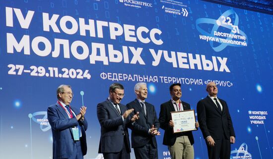 The 4th Young Scientists Congress. Plenary session. Winners of the BRICS Contest of Young Innovators announced. Award ceremony. From left: Gennady Krasnikov, President of the Russian Academy of Sciences; Valery Falkov, Minister of Science and Higher Education of the Russian Federation; Andrei Fursenko, Aide to the President of the Russian Federation; Thiago Edwiges, winner of the BRICS Young Innovator Prize (1st place), Brazil; and Dmitry Chernyshenko, Deputy Prime Minister of the Russian Federation. Location: Russia, Federal territory 'Sirius'. Author: Alexander Vilf. 4th Young Scientists Congress. Plenary session