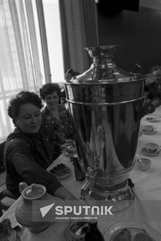 Perm Mashinostroitel Plant employees gather for tea around samovar