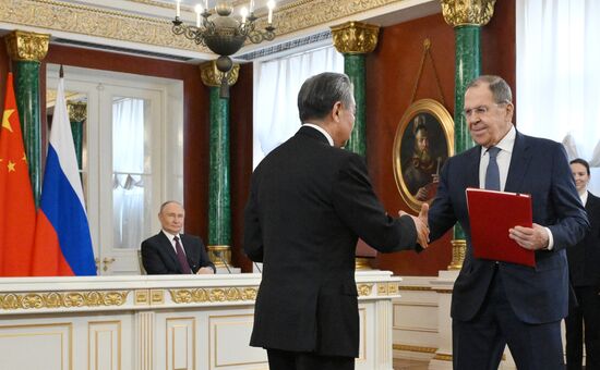 May 8, 2025. Russian Foreign Minister Sergei Lavrov and Wang Yi, Member of the Political Bureau of the CPC Central Committee, Director of the Office of the Central Commission for Foreign Affairs during a ceremony of exchanging documents after Russia-China talks. Back: President of Russia Vladimir Putin. Location: Russia, Moscow. Author: Alexei Danichev/Sputnik. President of China Xi Jinping's official visit to Russia