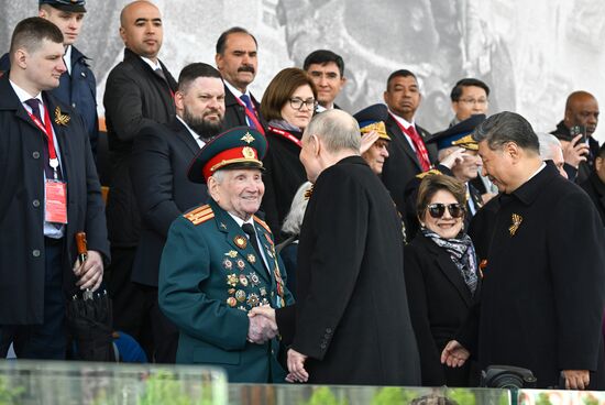 President of Russia Vladimir Putin greets a WWII veteran on Red Square in Moscow at the military parade to mark the 80th anniversary of Victory. On May 9, Russia celebrates the 80th anniversary of Victory in the Great Patriotic War of 1941-1945. Location: Russia, Moscow. Author: Sergey Bobylev/Sputnik. President of Russia Vladimir Putin and foreign leaders at military parade marking 80th anniversary of Victory