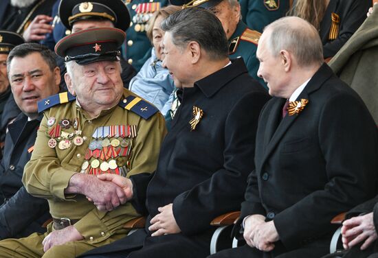 Russian President Vladimir Putin and Chinese President Xi Jinping, center, greet a WWII veteran on Red Square in Moscow at the military parade to mark the 80th anniversary of Victory. On May 9, Russia celebrates the 80th anniversary of Victory in the Great Patriotic War of 1941-1945. Location: Russia, Moscow. Author: Sergey Bobylev/Sputnik. President of Russia Vladimir Putin and foreign leaders at military parade marking 80th anniversary of Victory