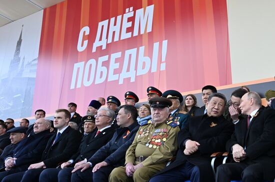 Russian President Vladimir Putin and Chinese President Xi Jinping on Red Square in Moscow during the military parade to mark the 80th anniversary of Victory. On May 9, Russia celebrates the 80th anniversary of Victory in the Great Patriotic War of 1941-1945. From left in the foreground: Prime Minister of Armenia Nikol Pashinyan, President of Belarus Alexander Lukashenko with his son Nikolai, President of Kazakhstan Kassym-Jomart Tokayev, President of Kyrgyzstan Sadyr Japarov and WWII veteran Yevgeny Znamensky. Location: Russia, Moscow. President of Russia Vladimir Putin and foreign leaders at military parade marking 80th anniversary of Victory