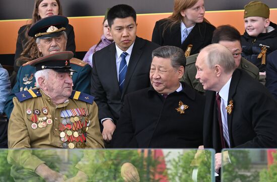 President of Russia Vladimir Putin and President of China President Xi Jinping talk to a veteran on Red Square in Moscow, where a military parade marking the 80th anniversary of Victory is taking place. Russia marks the 80th anniversary of Victory in the Great Patriotic War of 1941-1945. Location: Russia, Moscow. Author: Ilya Pitalev/Sputnik. President of Russia Vladimir Putin and foreign leaders at military parade marking 80th anniversary of Victory