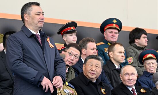 Center, foreground: President of Russia Vladimir Putin and President of China Xi Jinping, and President of the Kyrgyz Republic Sadyr Japarov, left, on Red Square in Moscow, where a military parade marking the 80th anniversary of Victory is taking place. Russia marks the 80th anniversary of Victory in the Great Patriotic War of 1941-1945. Location: Russia, Moscow. Author: Sergey Bobylev/Sputnik. President of Russia Vladimir Putin and foreign leaders at military parade marking 80th anniversary of Victory
