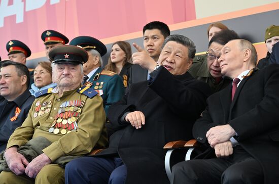 President of Russia Vladimir Putin and Chinese President Xi Jinping on Red Square in Moscow during the military parade to mark the 80th anniversary of Victory. On May 9, Russia celebrates the 80th anniversary of Victory in the Great Patriotic War of 1941-1945. Left: WWII veteran Yevgeny Znamensky. Location: Russia, Moscow. President of Russia Vladimir Putin and foreign leaders at military parade marking 80th anniversary of Victory