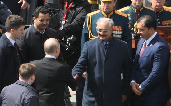 President of Russia Vladimir Putin and Head of the Libyan National Army Khalifa Haftar during a military parade to mark the 80th anniversary of Victory on Red Square in Moscow. Russia marks the 80th anniversary of Victory in the Great Patriotic War of 1941-1945. Location: Russia, Moscow. Author: Alexey Maishev/Sputnik. President of Russia Vladimir Putin and foreign leaders at military parade marking 80th anniversary of Victory