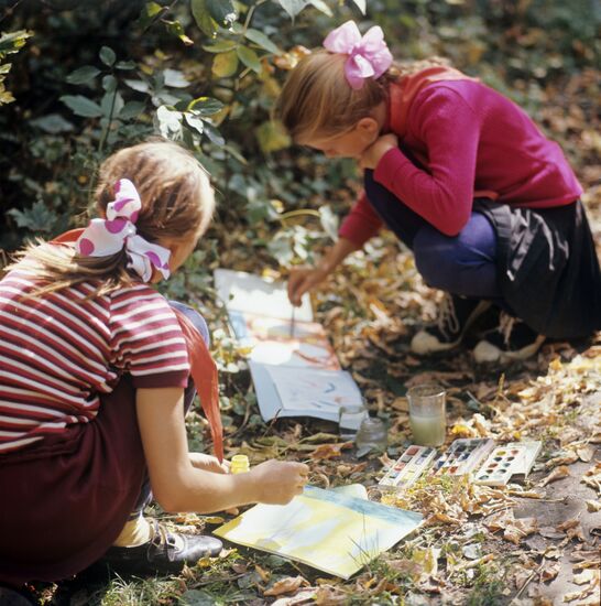 Children from art studio and their mentor A. Shevchwnko at open-air drawing session