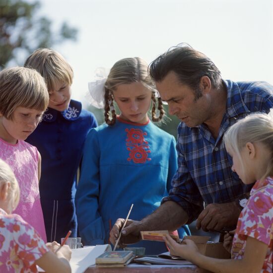 Children from art studio and their mentor A. Shevchwnko at open-air drawing session