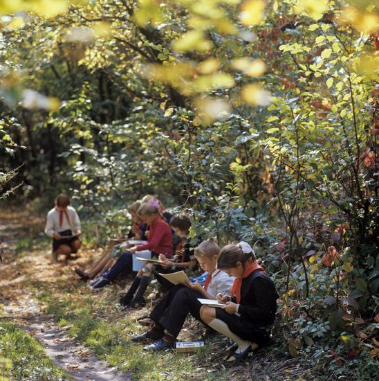 Children from art studio and their mentor A. Shevchwnko at open-air drawing session
