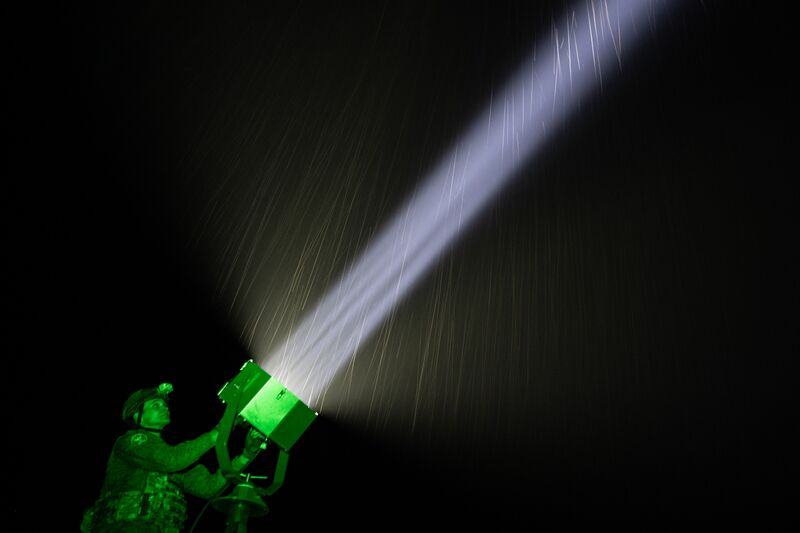 A Russian serviceman of the Zapad (West) Group of Forces lights the sky with a spotlight at an air observation post in the Krasny Liman (also known as Lyman) sector of the front line amid Russia's military operation in Ukraine, in the Lugansk People's Republic, Russia. Russia Ukraine Military Operation Air Defence