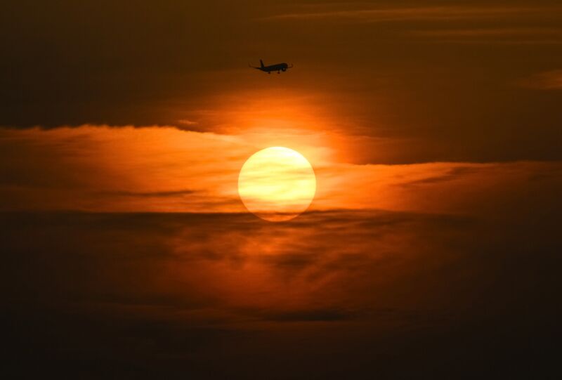 A plane flies at sunset over the Black Sea coast, in the Sirius Federal Territory, Krasnodar Region, Russia. Russia Daily Life