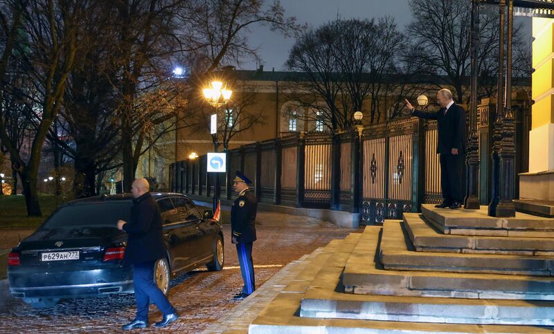 Russian President Vladimir Putin bids farewell to Hungarian Prime Minister Viktor Orban sitting in the motorcade as he leaves following their meeting, as Commandant of the Moscow Kremlin Sergei Udovenko stands nearby, at the Kremlin in Moscow, Russia. Russia Hungary
