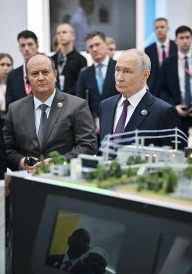 President Vladimir Putin, right, and Prime Minister of the Algerian People's Democratic Republic Sifi Ghrieb touring the Platform for Sovereign Development: Advanced Russian Solutions in Key Economic and Social Sectors exhibition, held on the sidelines of the Russia–Africa Economic and Humanitarian Forum in Moscow. Location: Russia, Moscow. Author: Yuri Kochetkov/Sputnik. President Vladimir Putin visits exhibition of advanced Russian solutions at the Russia-Africa Forum