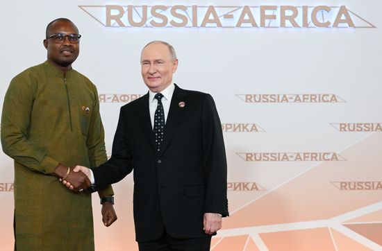 President Vladimir Putin during an official greeting ceremony for heads of delegation at the 3rd Russia-Africa Summit. Left: Prime Minister of Burkina Faso Rimtalba Jean Emmanuel Ouedraogo. Location: Russia, Moscow. Author: Alexandr Kryazhev/Sputnik. President Vladimir Putin officially greets heads of delegation at Russia-Africa Summit