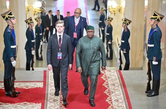 Adviser to the President of Sierra Leone Alhaji Timothy Musa Kabba, center, arrives at the Kremlin for a plenary session and a group photo of the 3rd Russia-Africa Summit and Forum participants. Back: Ambassador Extraordinary and Plenipotentiary of Sierra Leone to Russia Mohamed Yongawo. Location: Russia, Moscow. Author: Yuri Kochetkov/Sputnik. Russia-Africa Summit and Forum group photo